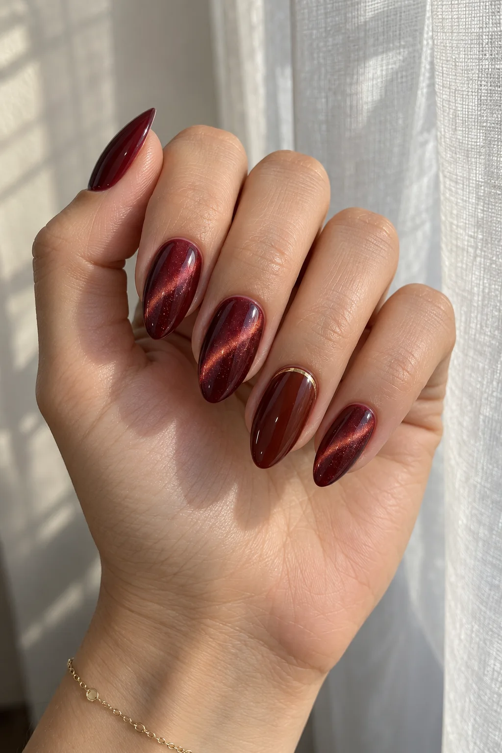 Burgundy velvet cat-eye nails to wear with a red dress