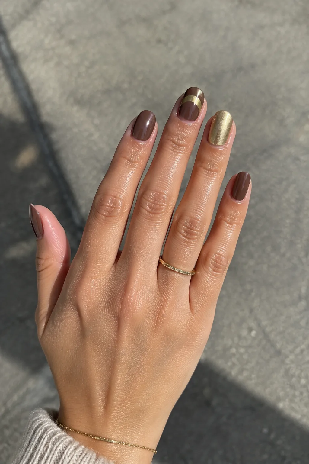 Cocoa brown short round nails with gold chrome, nails to wear with a red dress