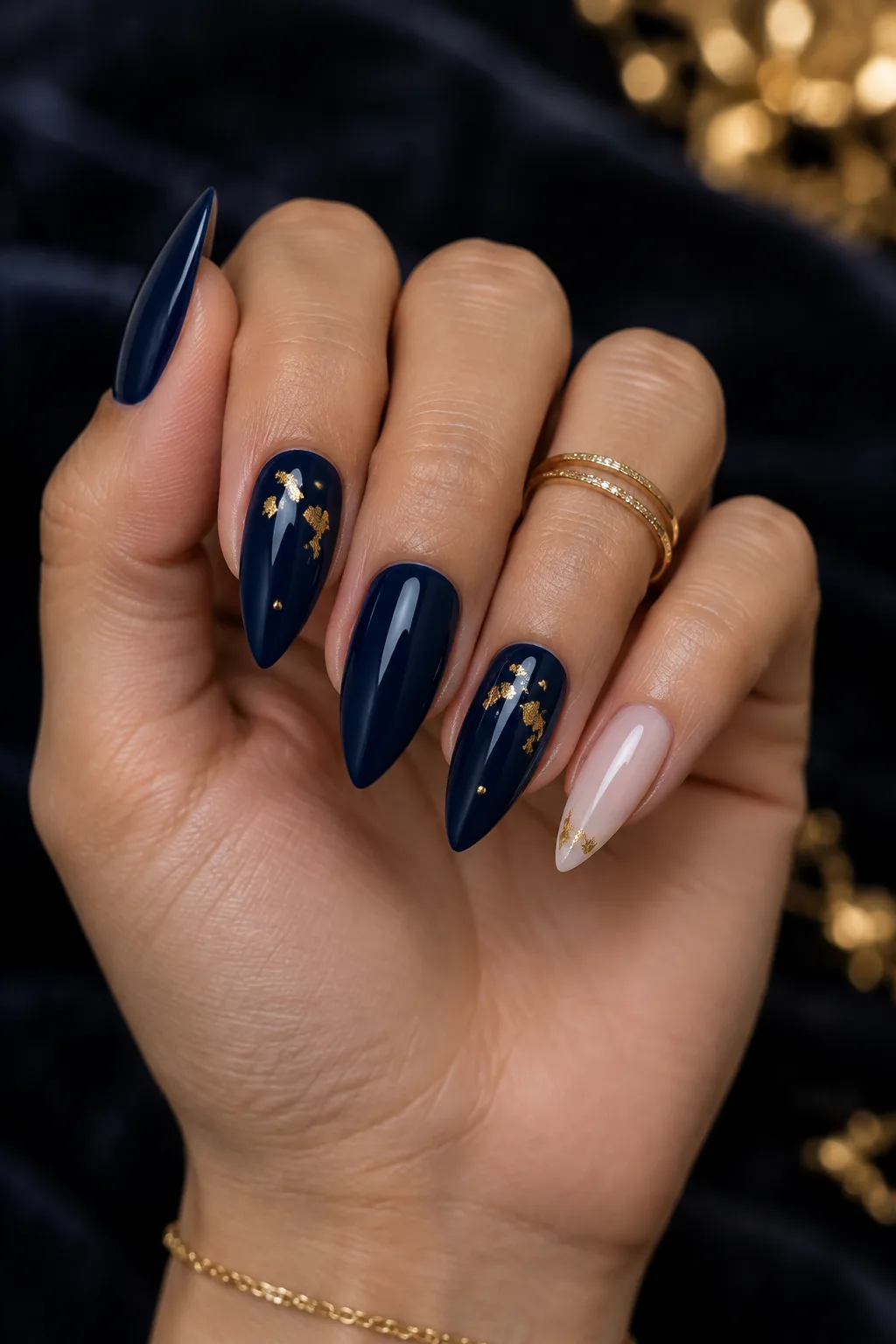 Navy stiletto nails with flat gold leaf flecks for winter