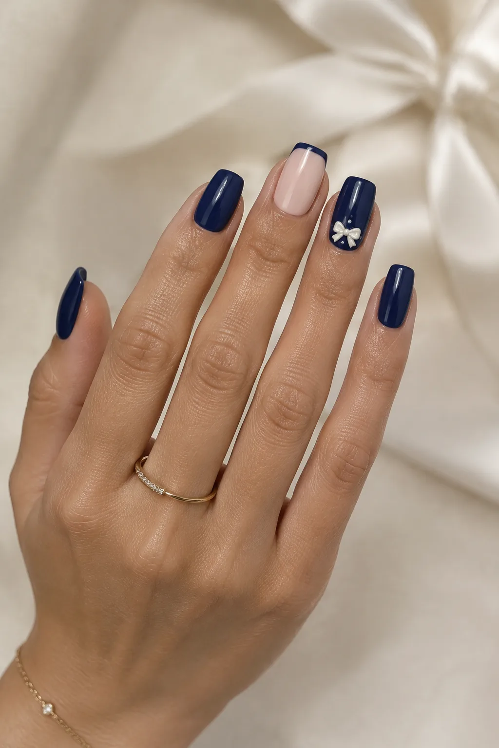 Navy square nails with a small 3D ivory gel bow for winter