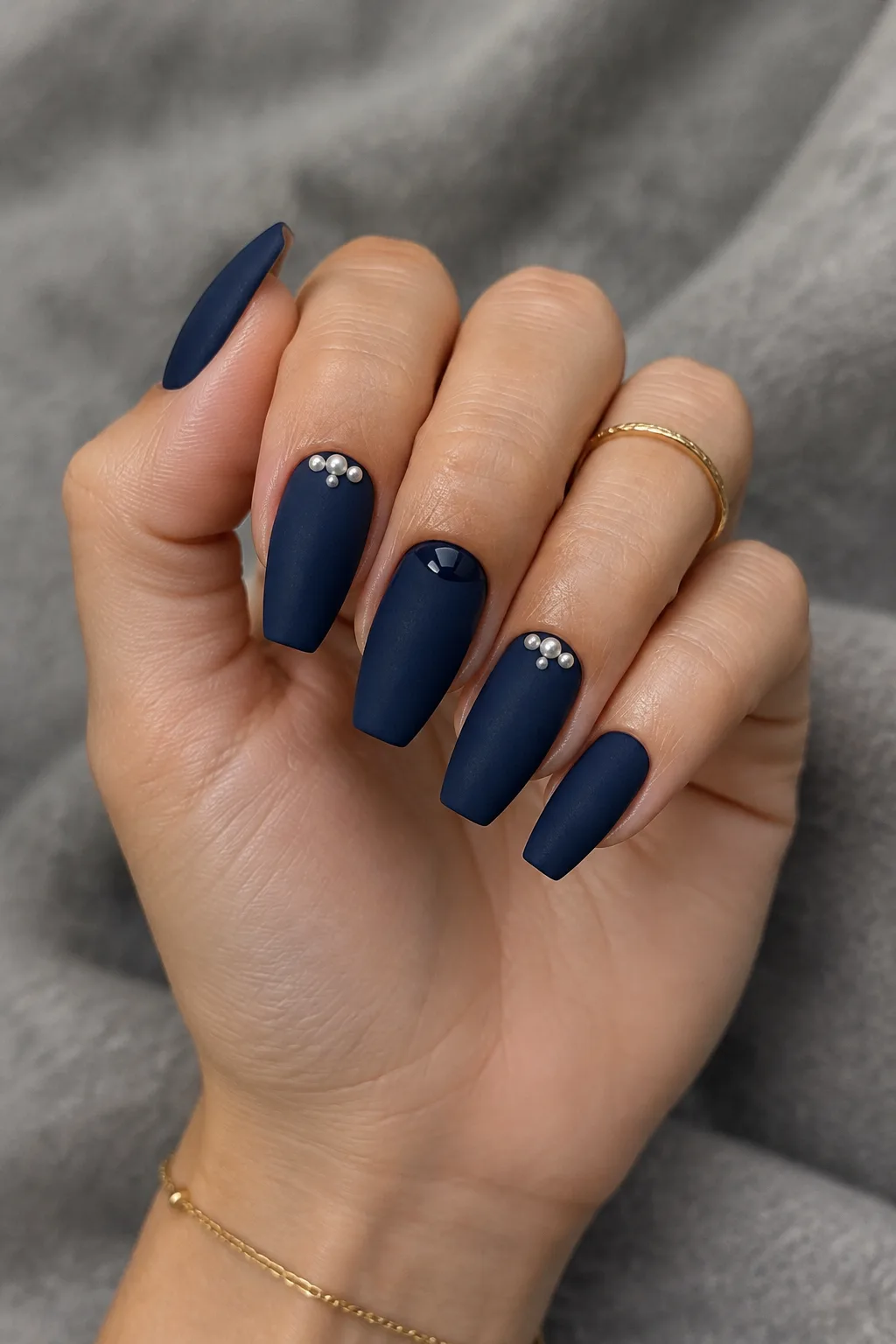 Matte navy coffin nails with tiny pearl cuticle accents for winter