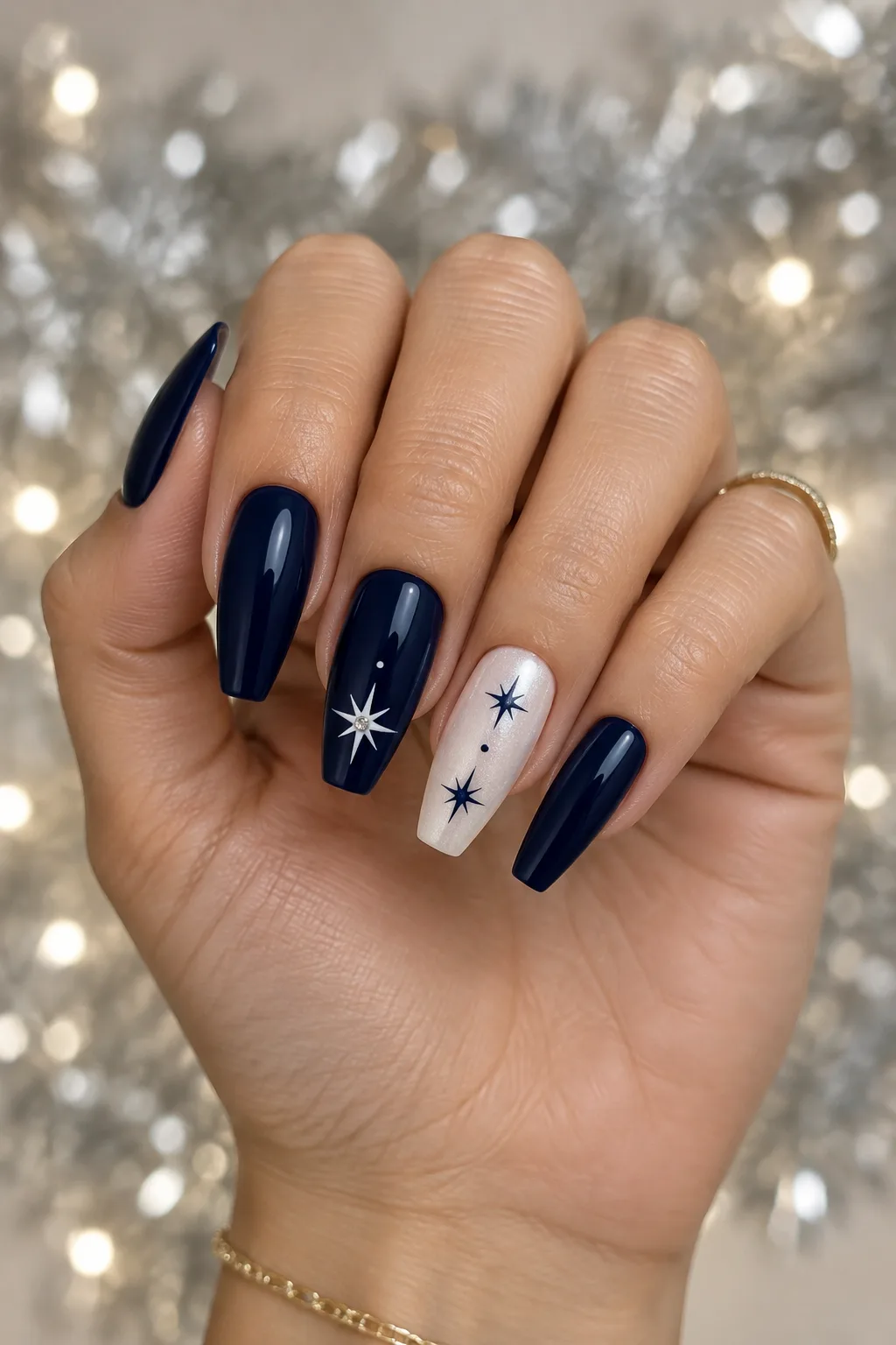 Navy nails with tiny white star flecks and a rhinestone center for winter