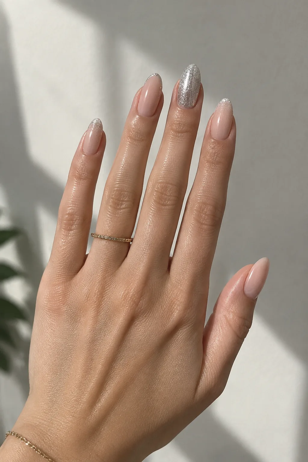 New Year's Eve nails 2027 with sheer nude and one silver glitter accent nail