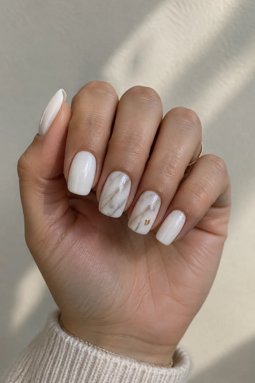 White marble and gold vein New Year's Eve nails 2027 on medium squoval nails