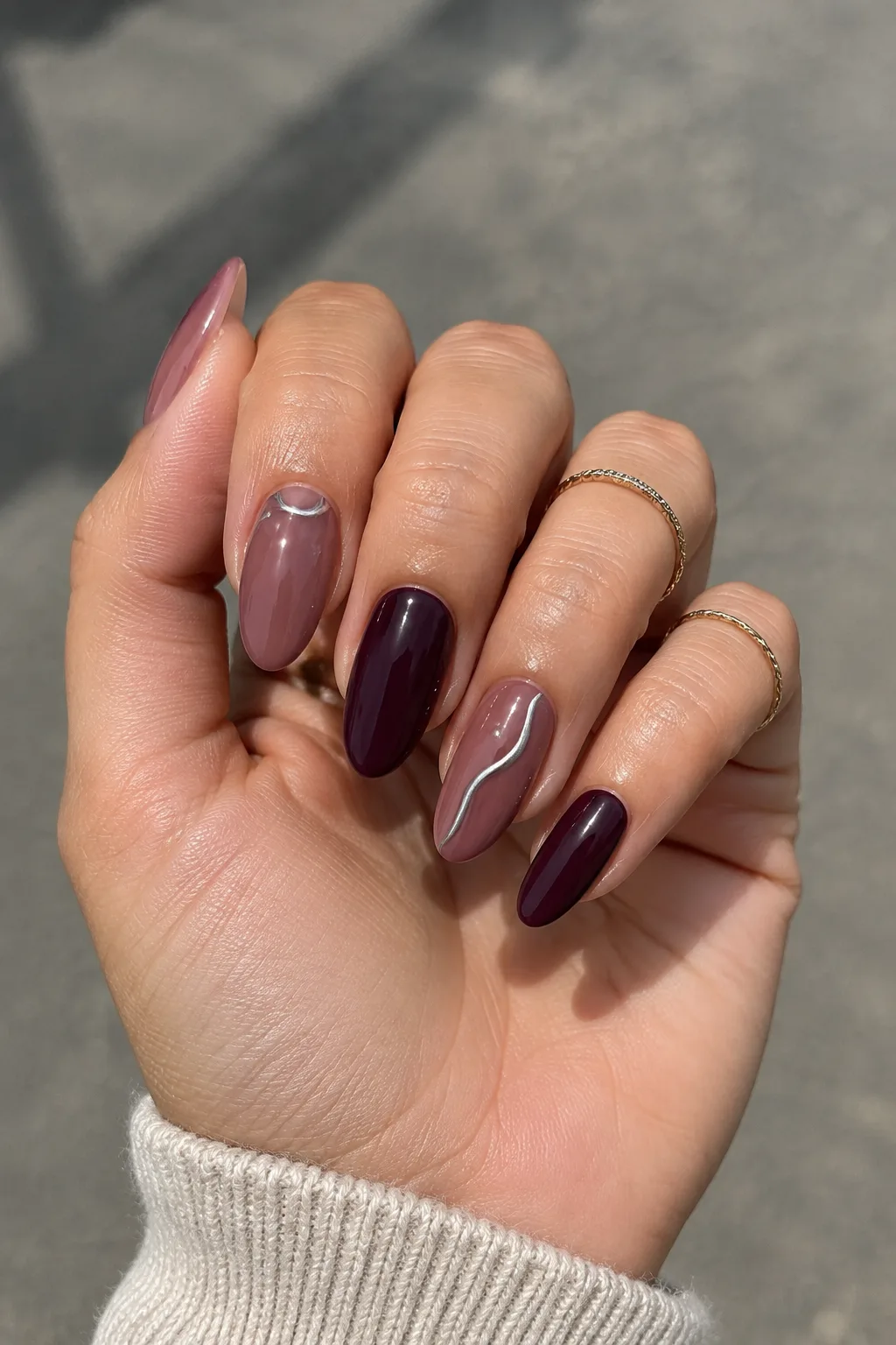 Plum and silver swirl New Year's Eve nails 2027 on long almond nails