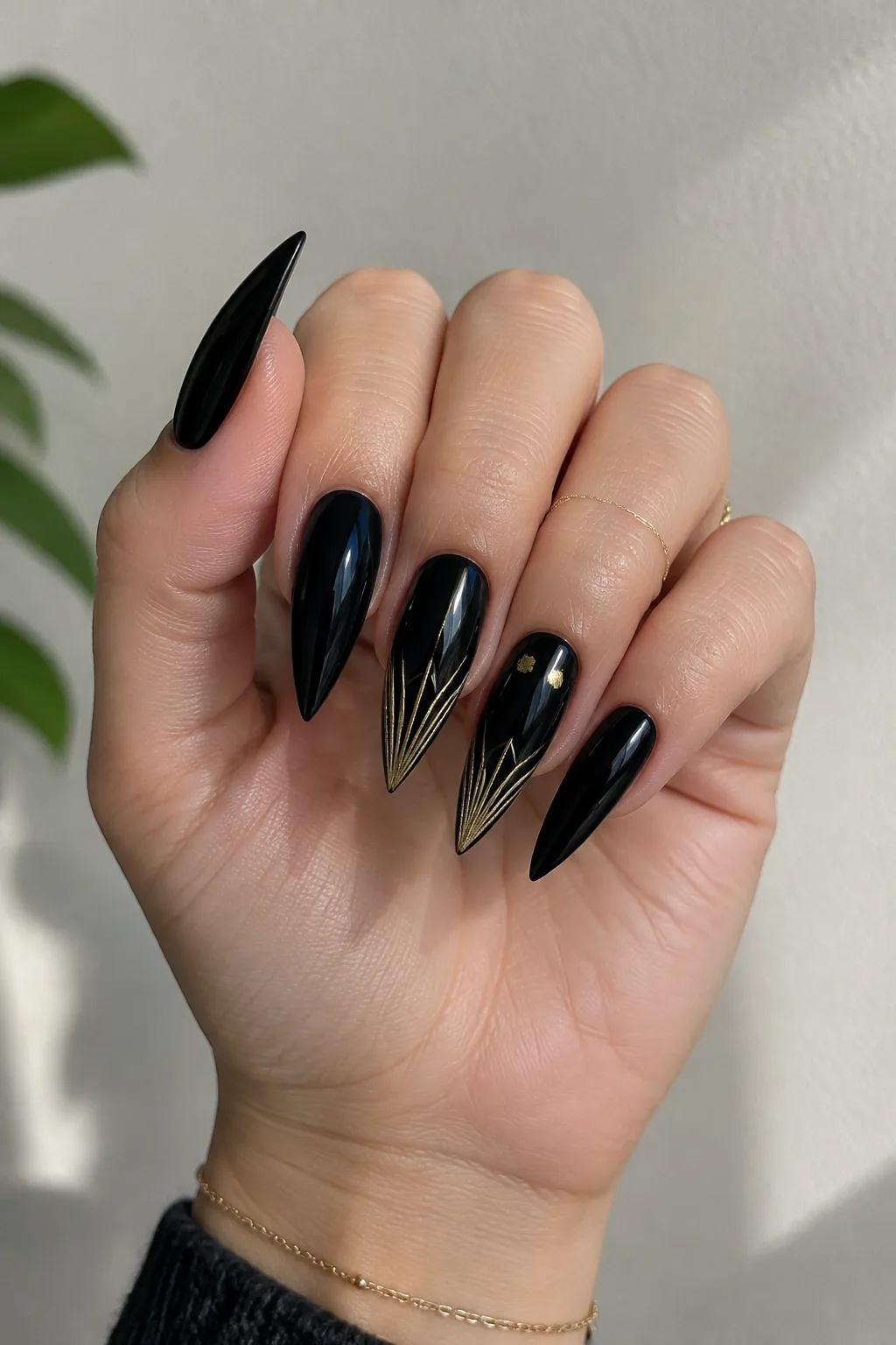 Ink black and gold fan line New Year's Eve nails 2027 on long arrowhead nails
