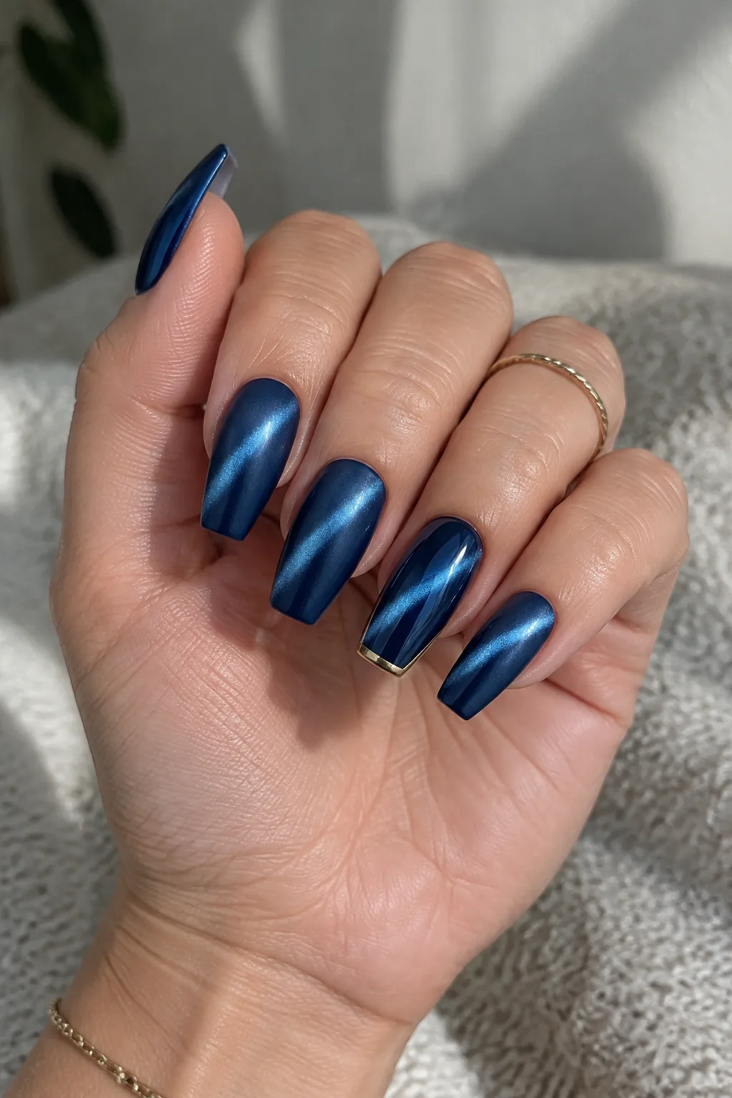 Sapphire cat-eye New Year's Eve nails 2027 on medium coffin nails with gold line