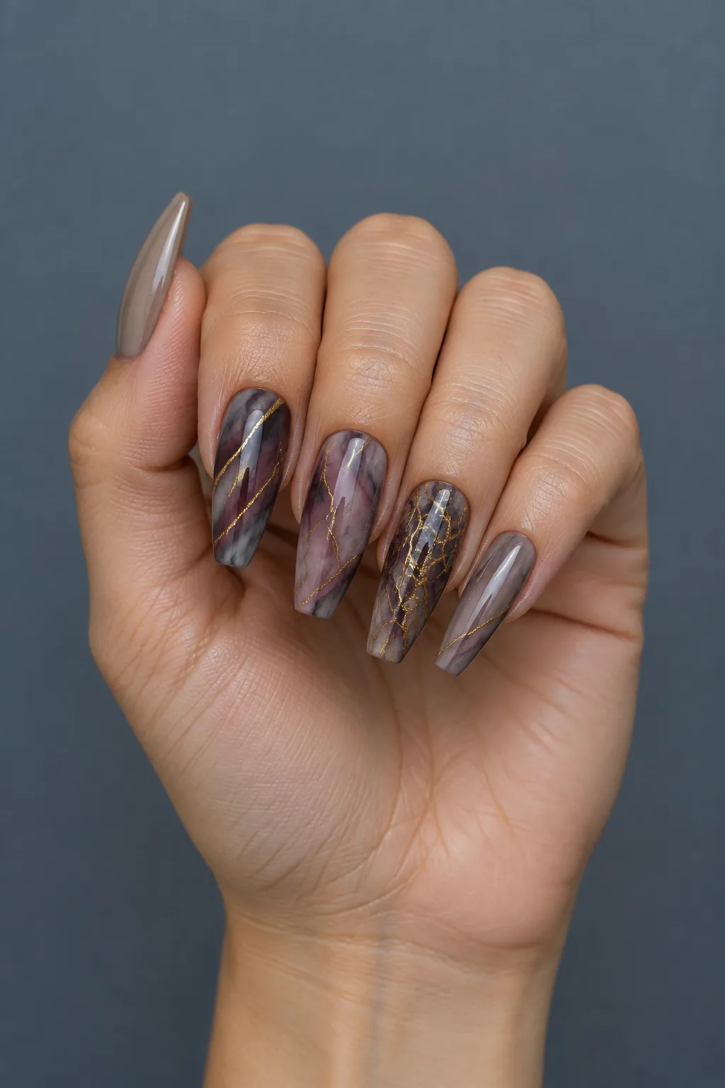 Plum and taupe marble ballerina nails with gold veins for October 2026