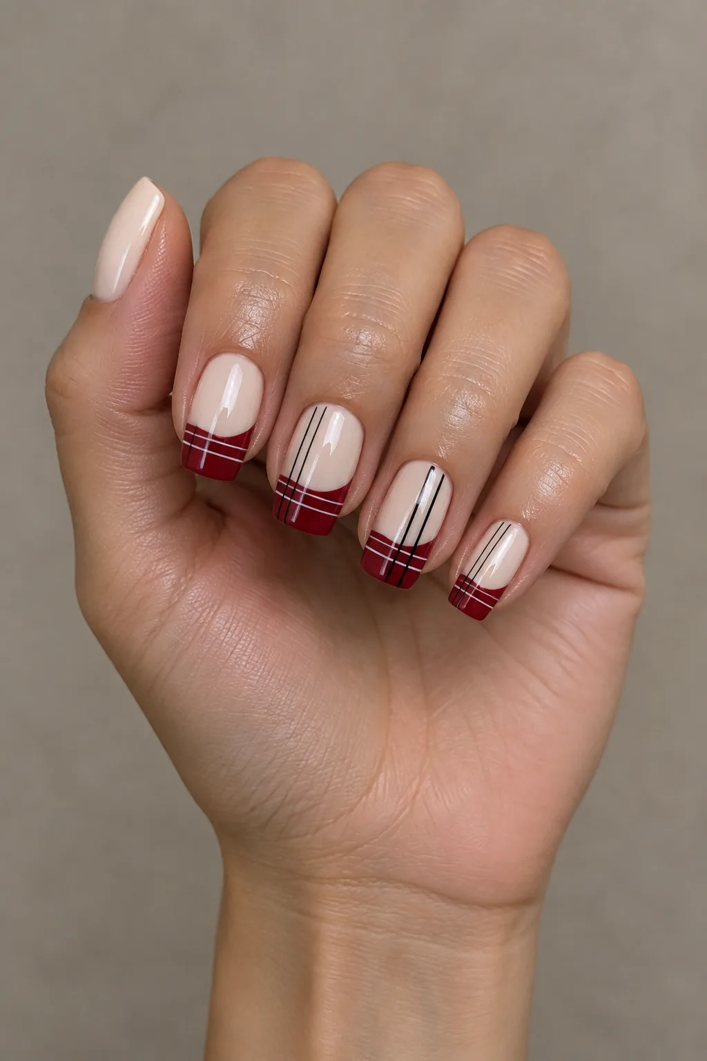 Cream plaid nails for fall with red tartan French tips and black and white lines