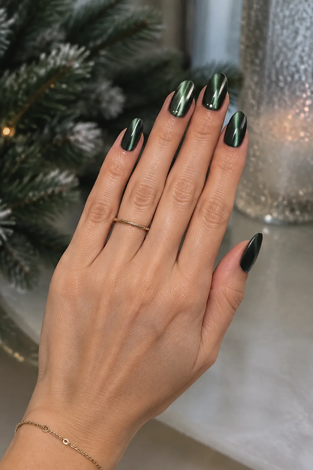 Short christmas nails in deep green velvet cat-eye with silver shine