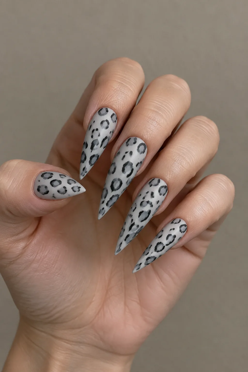 Snow leopard print stiletto nail designs in grey and charcoal