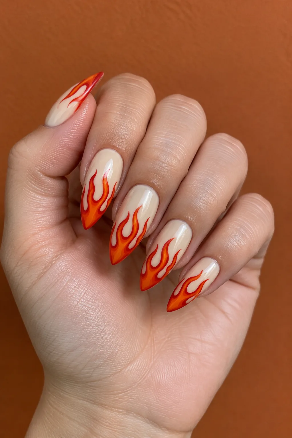 Flame tip stiletto nail designs in orange and red on cream