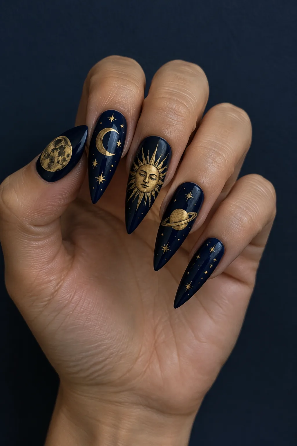 Celestial stiletto nail designs in gold on navy, mix and match set