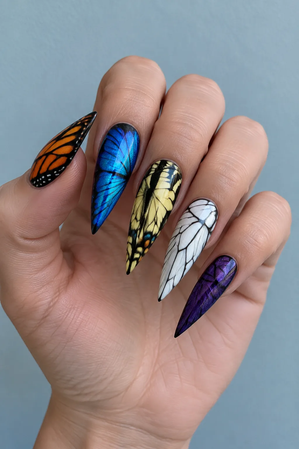 Butterfly wing stiletto nail designs with a different wing on each nail