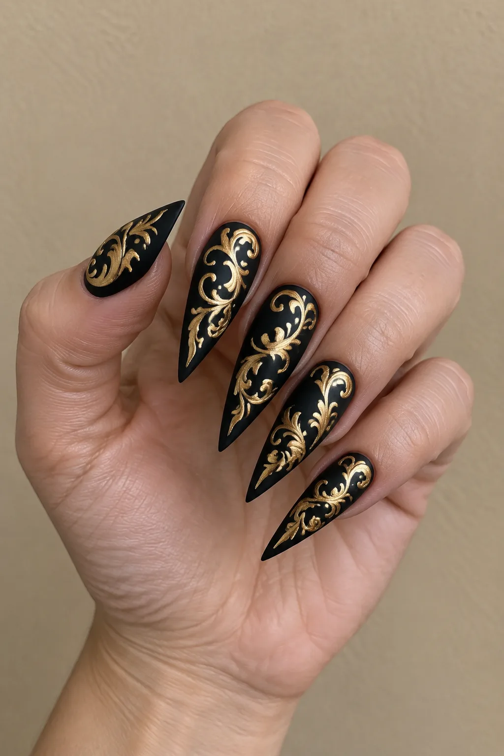 Baroque gold filigree stiletto nail designs on matte black