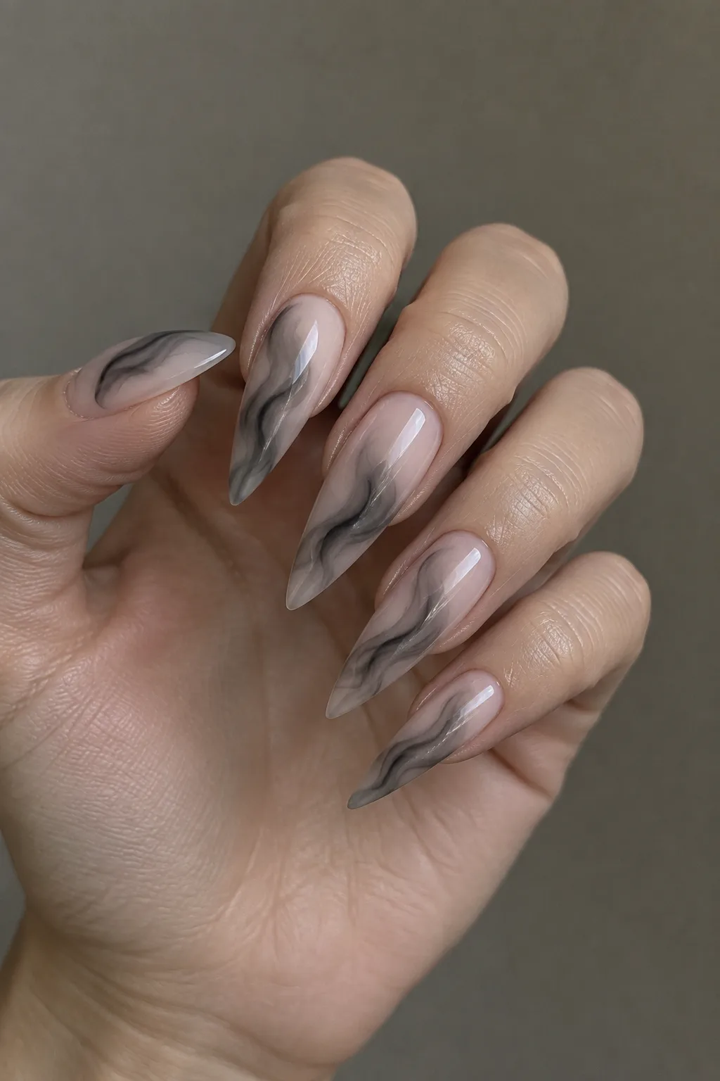 Smoke swirl stiletto nail designs in charcoal grey over nude