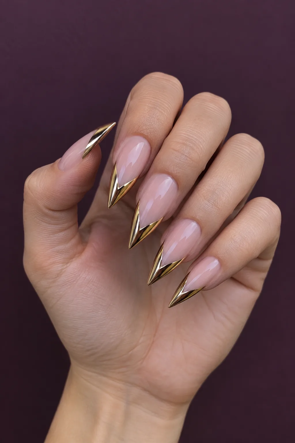 Gold chrome tip stiletto nail designs over a nude base