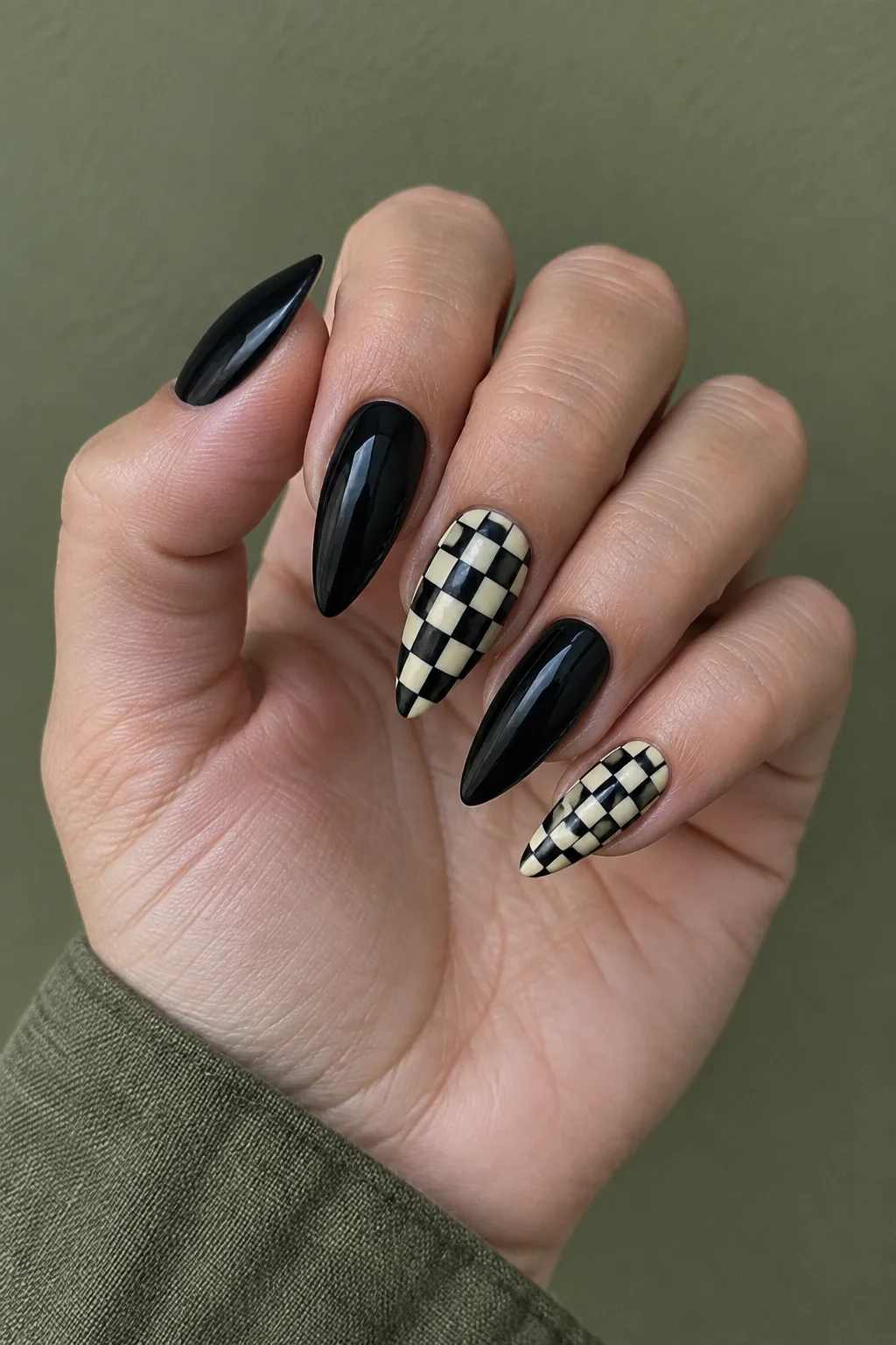 Black and white checkerboard stiletto nail designs with glossy black accents