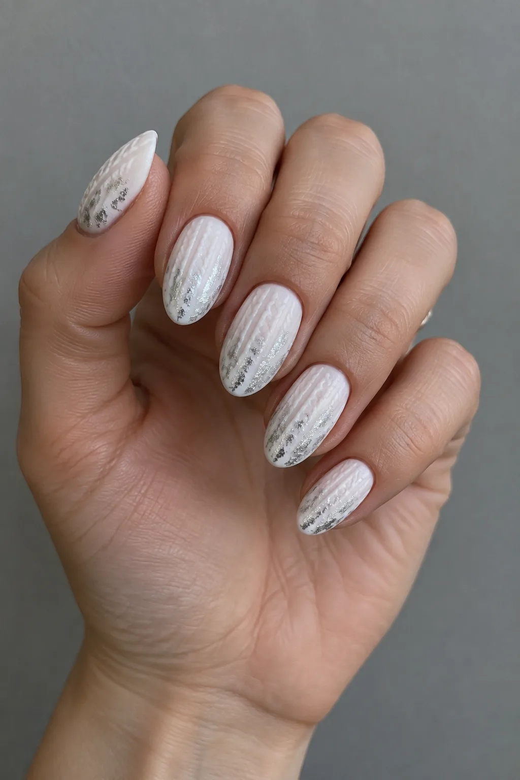 Pearl knit sweater nails with silver foil flakes on short almond nails