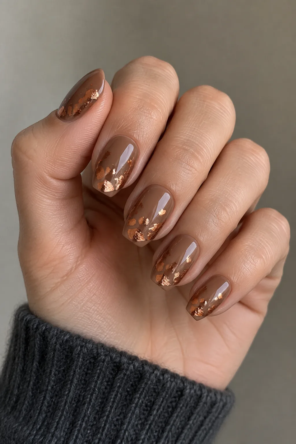 Cocoa brown base with scattered copper foil flakes on short round nails