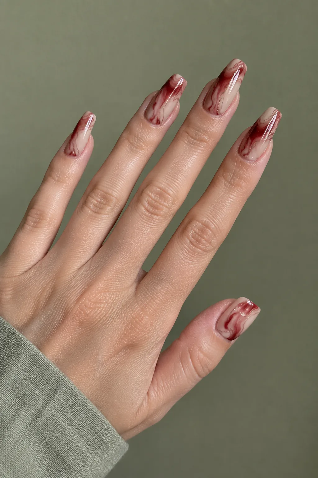 Cranberry and copper marbled swirl design on short nails with a glossy topcoat