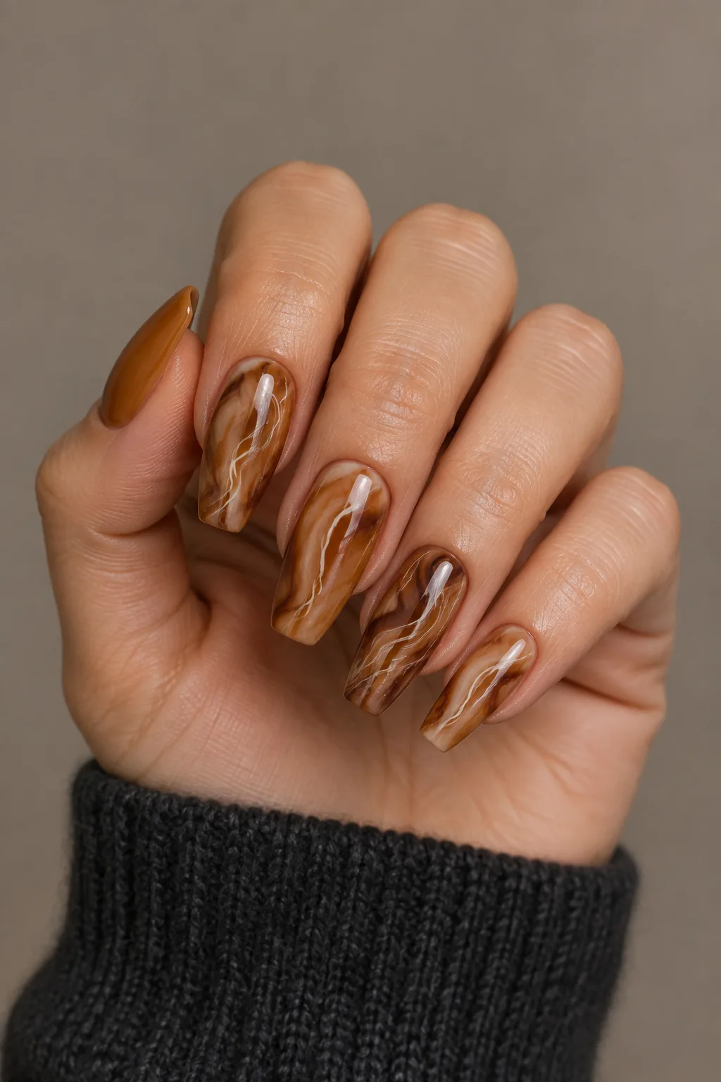 Marbled tortoiseshell nails in amber and cocoa on flare shaped nails