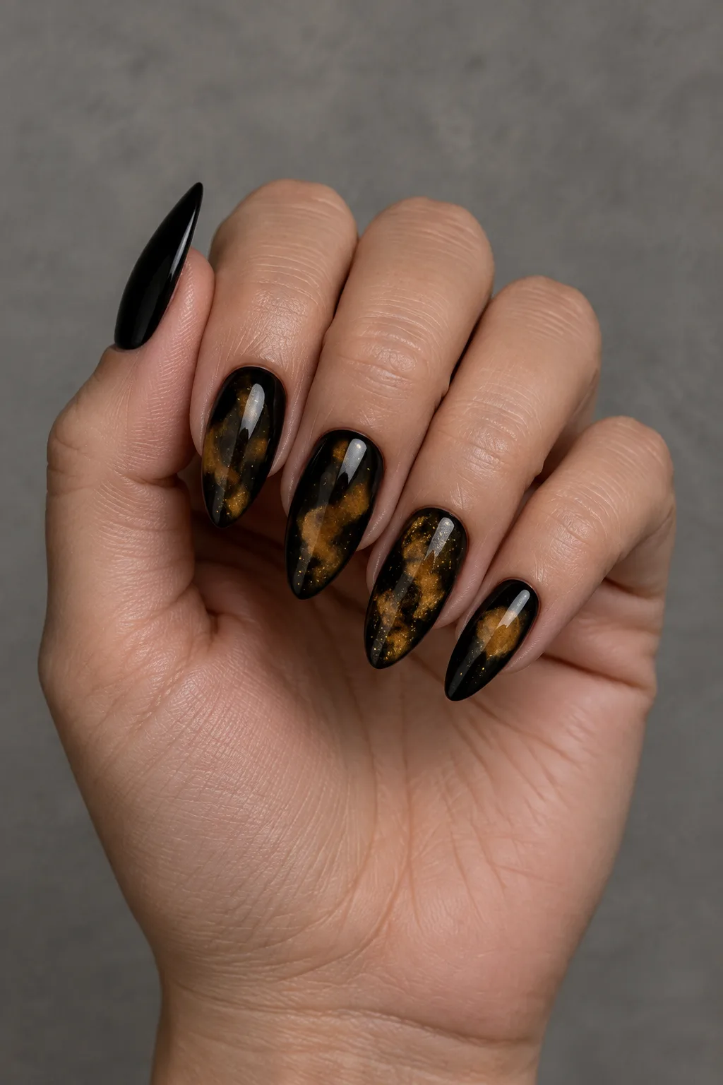 Black and gold tortoiseshell nails on arrowhead shaped nails