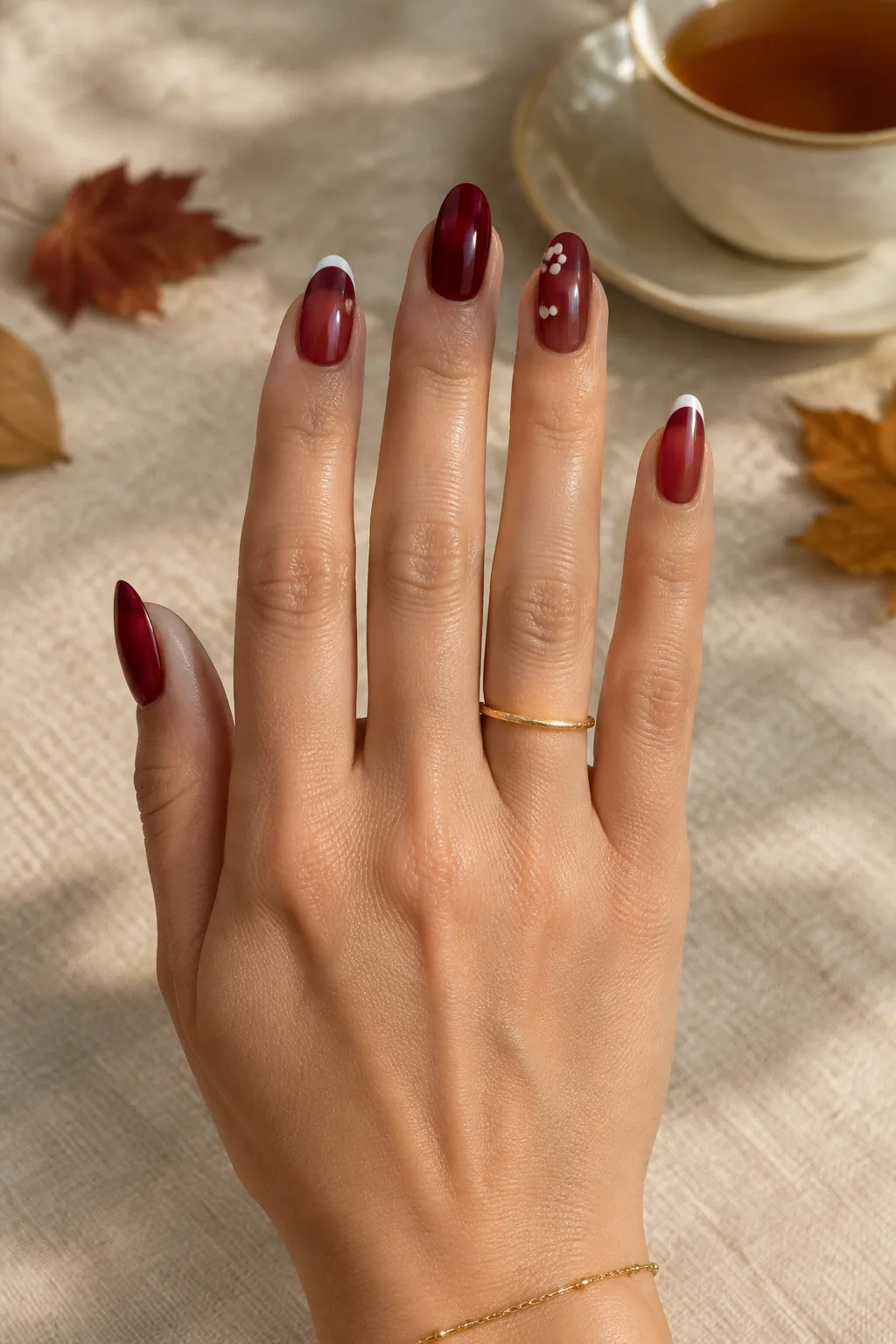 Sheer cranberry jelly nails with white dots, a test shade for the salon