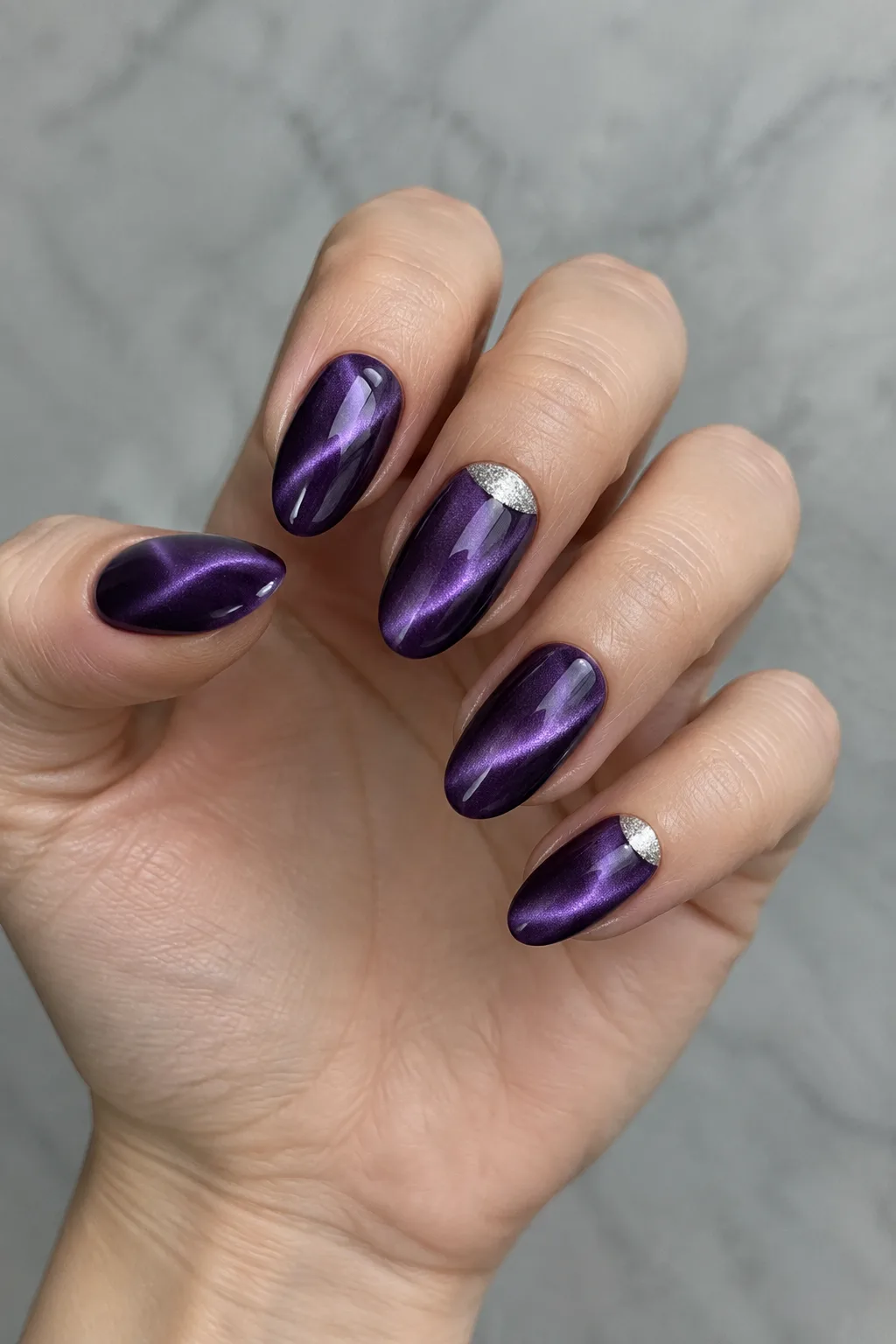 Amethyst purple velvet nails with silver glitter half-moon accents, winter manicure